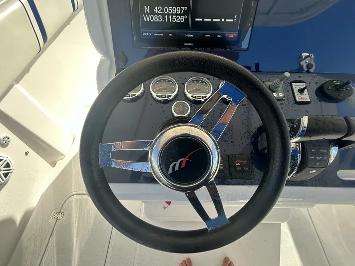  Yacht Photos Pics Steering wheel of a 2016 Midnight Express 37 Open boat with navigation display.