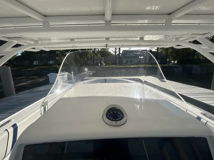  Yacht Photos Pics 2016 Midnight Express 37 Open boat with clear windshield and compass, docked at marina.