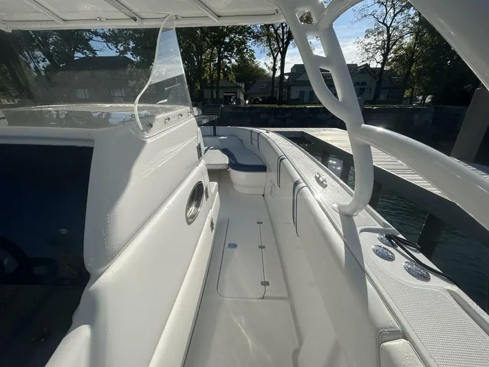  Yacht Photos Pics 2016 Midnight Express 37 Open boat, sleek white interior, docked by waterfront homes.