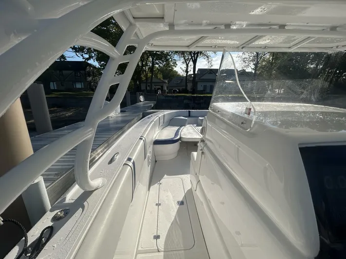  Yacht Photos Pics 2016 Midnight Express 37 Open boat interior with seating and helm, docked in sunlight.