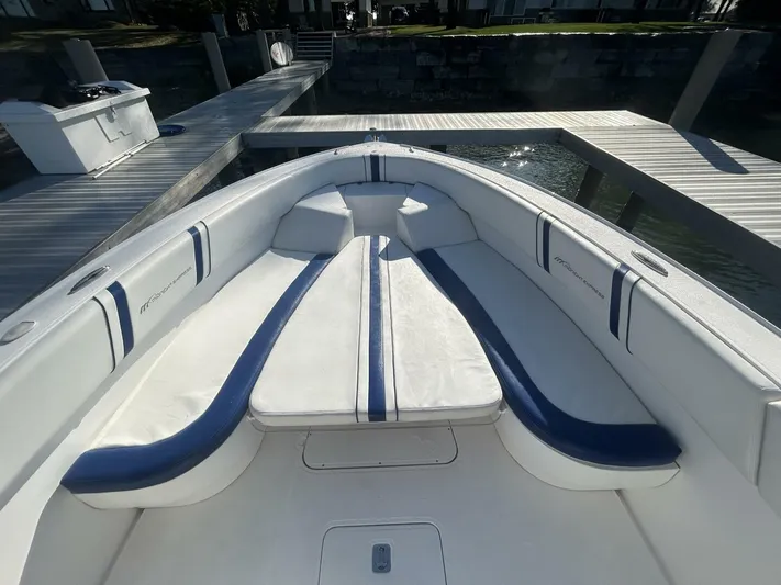  Yacht Photos Pics 2016 Midnight Express 37 Open boat interior with white and blue seating at dock.