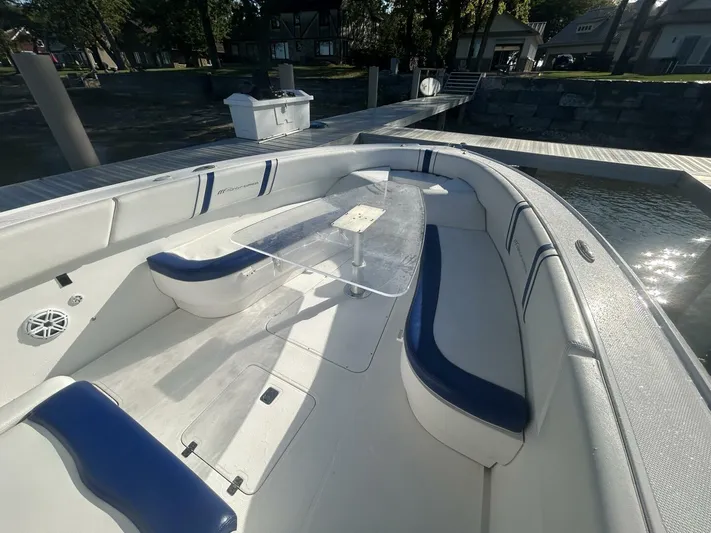  Yacht Photos Pics 2016 Midnight Express 37 Open boat with blue and white seating, docked by the water.