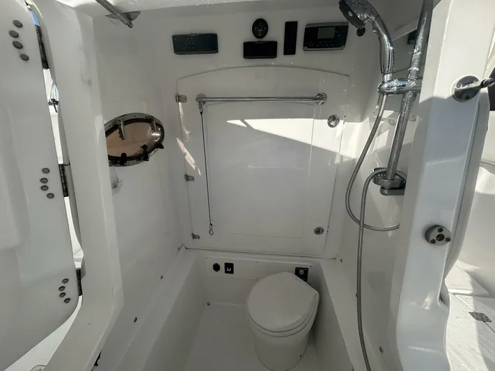  Yacht Photos Pics Interior of 2016 Midnight Express 37 Open boat bathroom with shower and toilet.