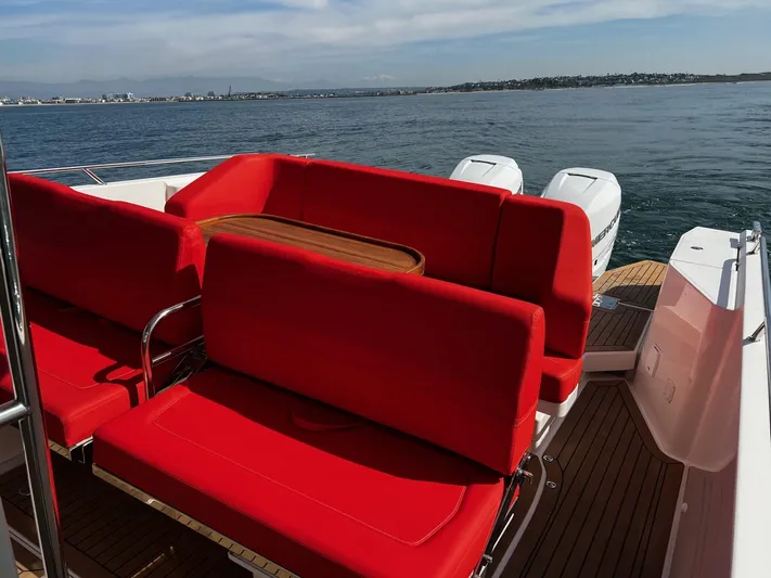 Mdr Yacht Photos Pics Nimbus T11 2021 boat with red seating and wooden deck on open water.