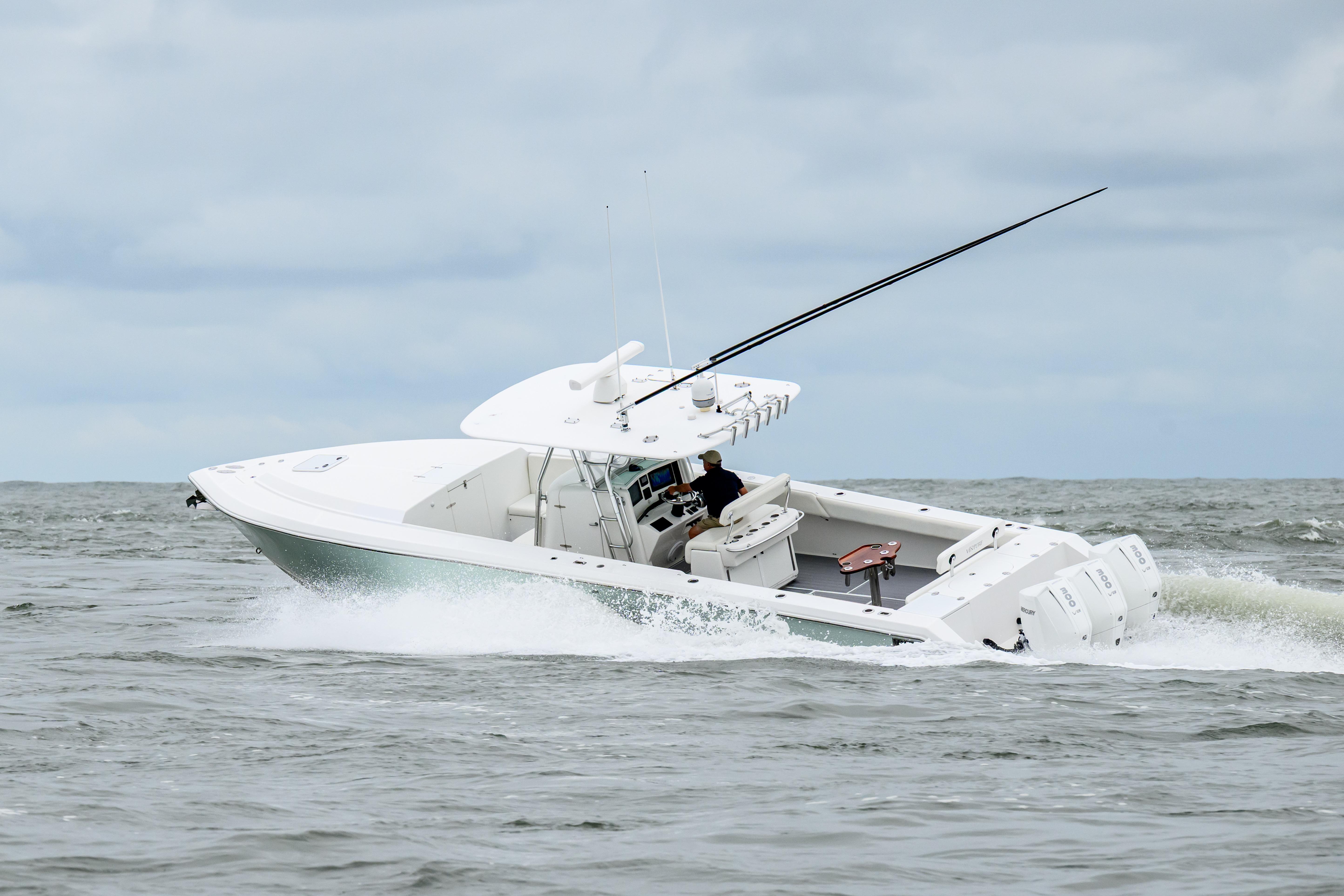 2008 Venture 39 Cuddy boat navigating choppy waters under cloudy skies.