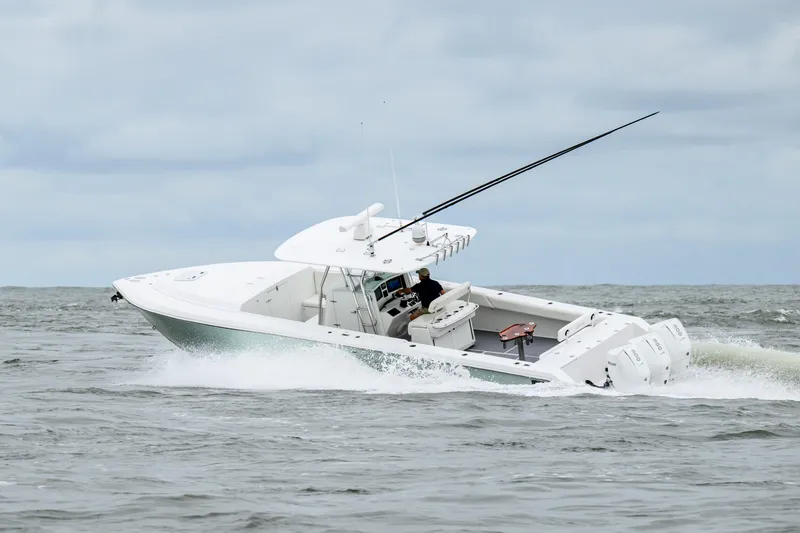 Comeback Yacht Photos Pics 2008 Venture 39 Cuddy boat navigating choppy waters under cloudy skies.