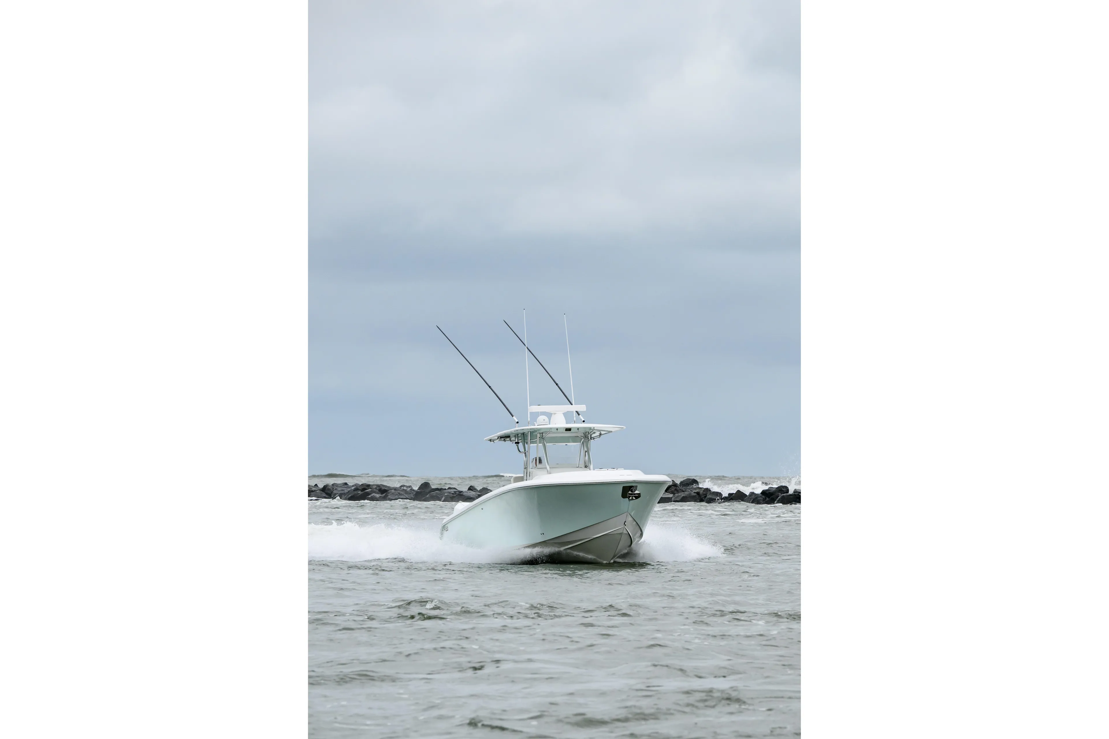2008 Venture 39 Cuddy boat navigating through choppy waters under cloudy skies.