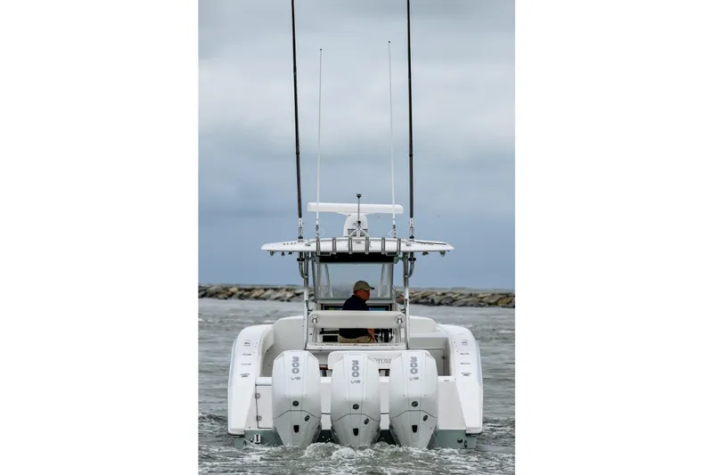 Comeback Yacht Photos Pics 2008 Venture 39 Cuddy boat with triple engines navigating through water.