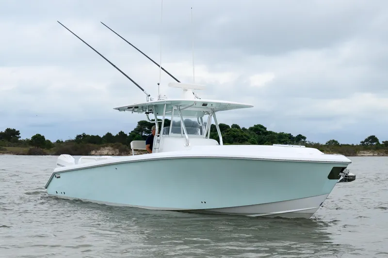 Comeback Yacht Photos Pics 2008 Venture 39 Cuddy boat on water, overcast sky, coastal background.