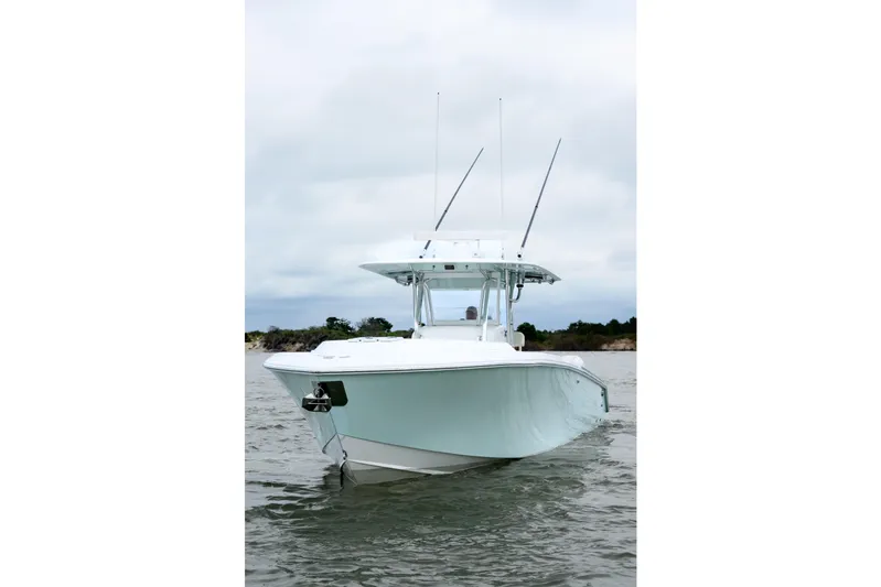 Comeback Yacht Photos Pics 2008 Venture 39 Cuddy boat on water, front view with antennas, cloudy sky.