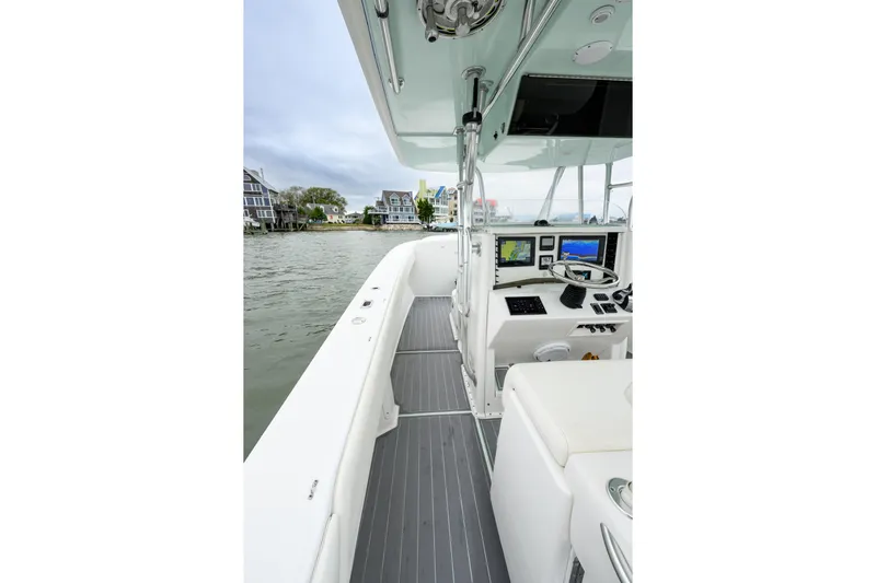 Comeback Yacht Photos Pics 2008 Venture 39 Cuddy boat interior with navigation equipment and waterfront view.