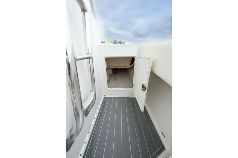 Comeback Yacht Photos Pics 2008 Venture 39 Cuddy boat interior storage compartment with open door, showcasing sleek design.