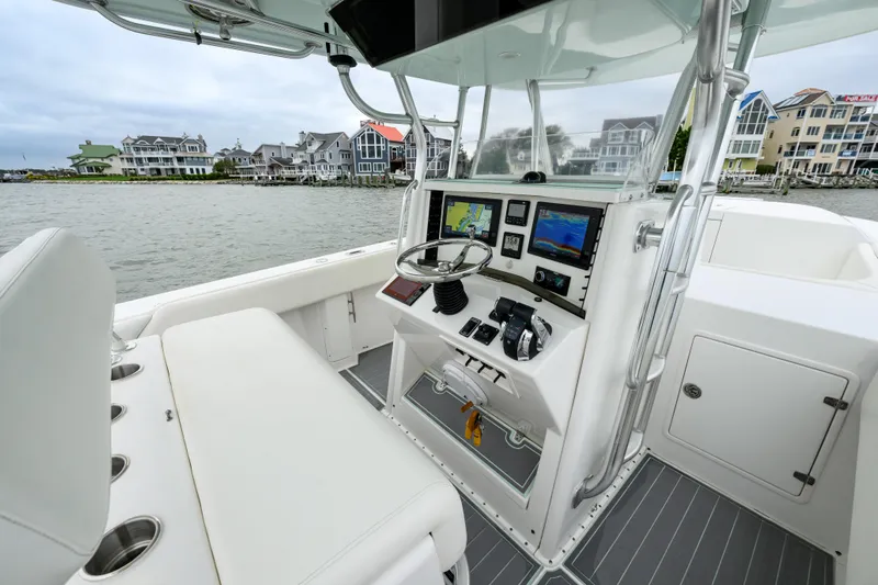 Comeback Yacht Photos Pics 2008 Venture 39 Cuddy boat interior with modern navigation equipment and waterfront view.