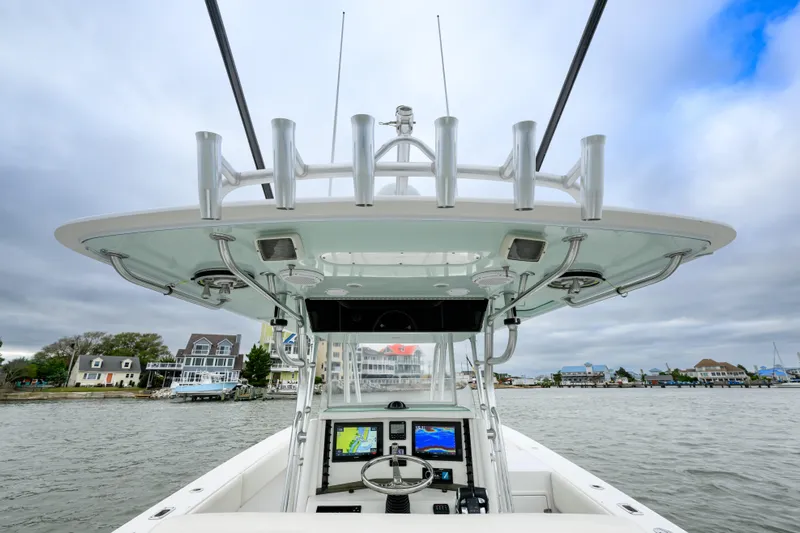 Comeback Yacht Photos Pics 2008 Venture 39 Cuddy boat helm with navigation screens, docked near waterfront homes.