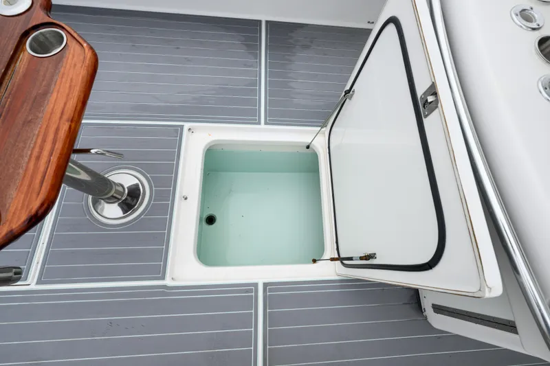 Comeback Yacht Photos Pics Open storage compartment on 2008 Venture 39 Cuddy boat deck with gray flooring.