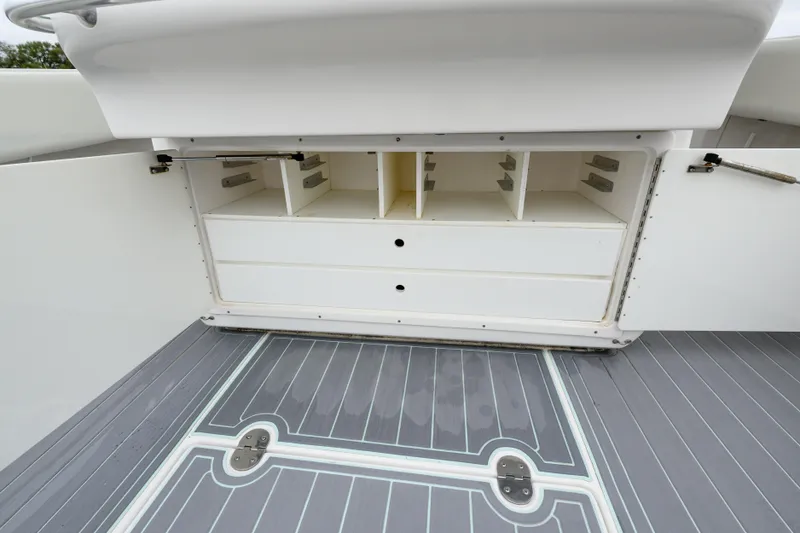 Comeback Yacht Photos Pics 2008 Venture 39 Cuddy boat storage compartments with open doors and gray deck flooring.