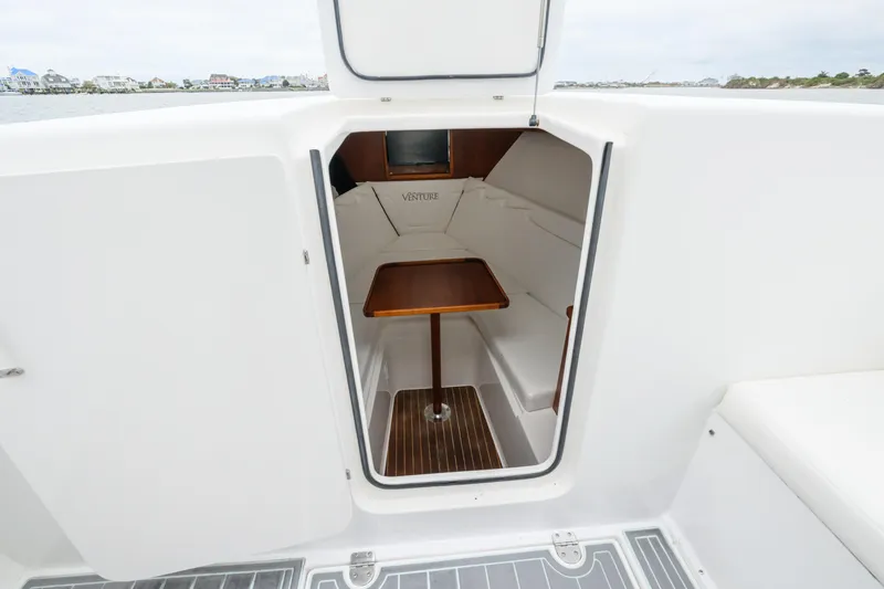 Comeback Yacht Photos Pics 2008 Venture 39 Cuddy cabin interior with seating and wooden table.