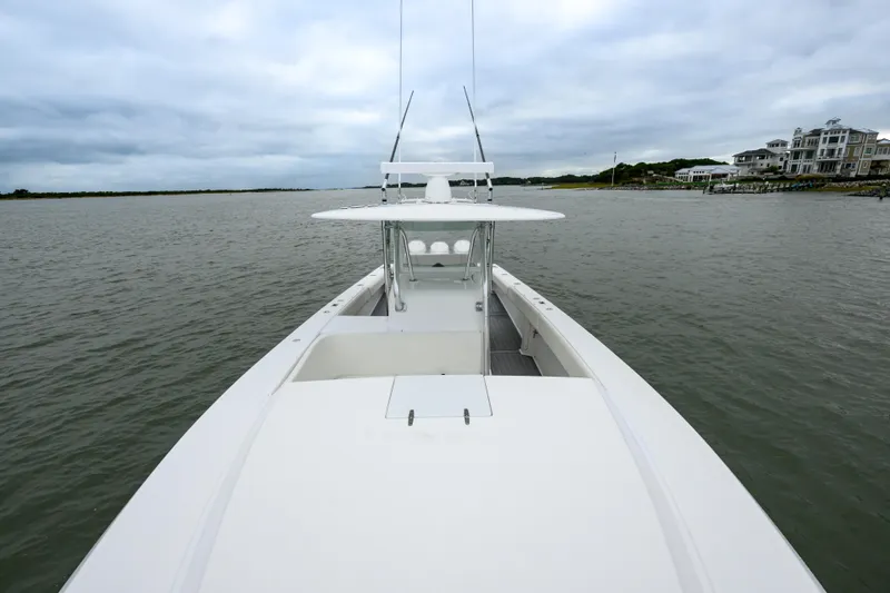 Comeback Yacht Photos Pics 2008 Venture 39 Cuddy boat on calm waters, overcast sky, coastal homes in background.