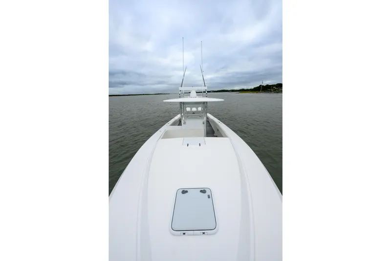Comeback Yacht Photos Pics 2008 Venture 39 Cuddy boat on calm water under cloudy sky.