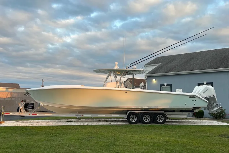 Comeback Yacht Photos Pics 2008 Venture 39 Cuddy boat on trailer, parked outdoors under cloudy sky.