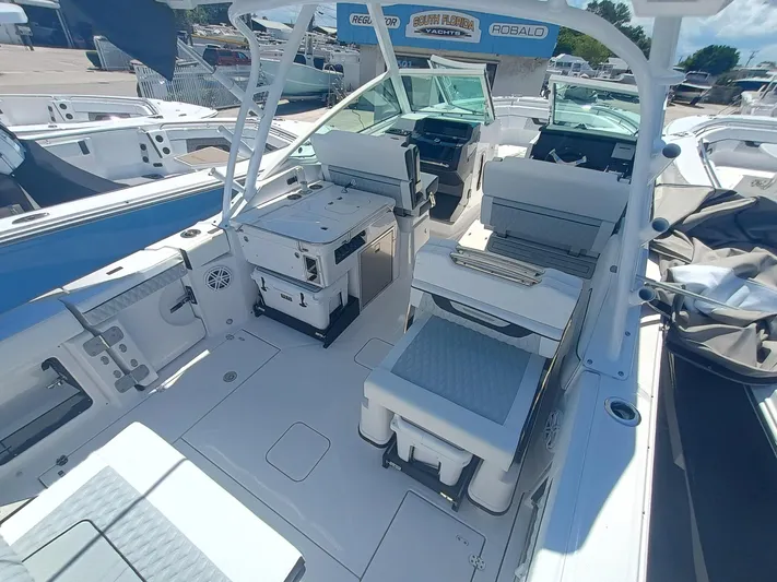  Yacht Photos Pics 2025 Blackfin 302 DC boat interior with seating and helm, docked at a marina.