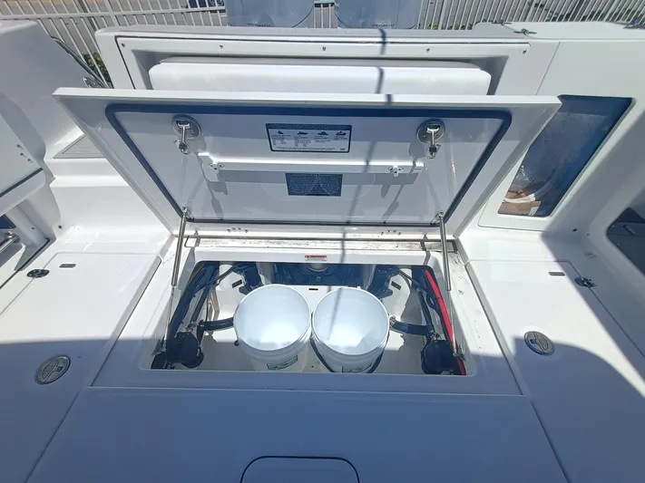 Yacht Photos Pics 2025 Blackfin 302 DC boat storage compartment with open hatch and buckets inside.