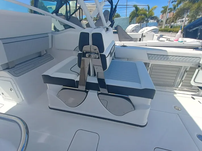  Yacht Photos Pics 2025 Blackfin 302 DC boat interior with cushioned seating and modern design.