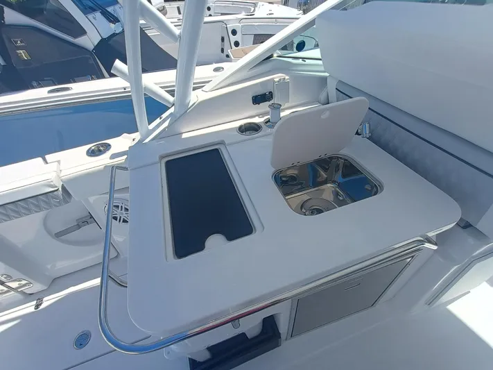  Yacht Photos Pics 2025 Blackfin 302 DC boat interior with sink and storage area.