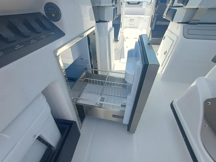  Yacht Photos Pics 2025 Blackfin 302 DC boat interior with open stainless steel drawer fridge.