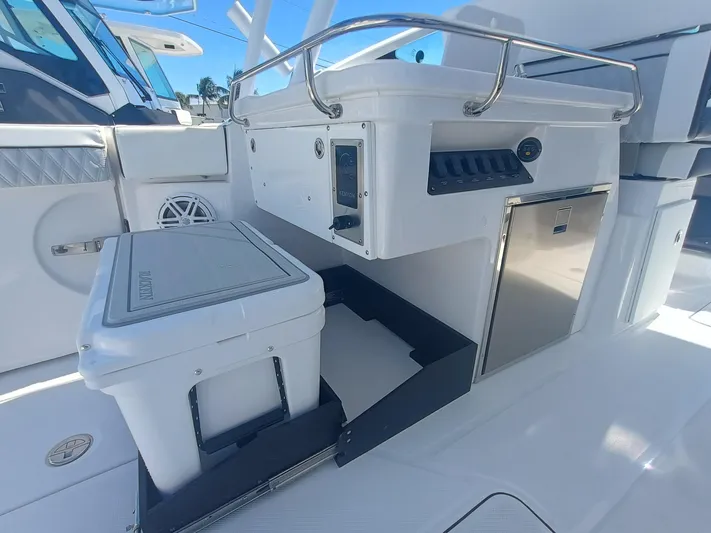  Yacht Photos Pics 2025 Blackfin 302 DC boat interior with cooler, storage, and control panel.