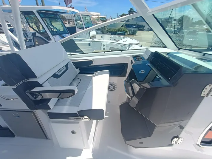  Yacht Photos Pics 2025 Blackfin 302 DC boat interior with modern seating and control panel.