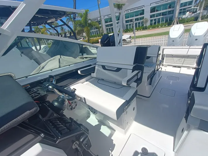  Yacht Photos Pics 2025 Blackfin 302 DC boat interior with modern seating and controls, docked outdoors.