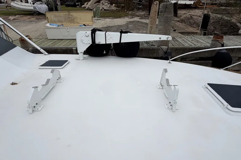 Pura Vida Yacht Photos Pics 1985 Bertram 54 Convertible yacht deck with davit and hatch covers.