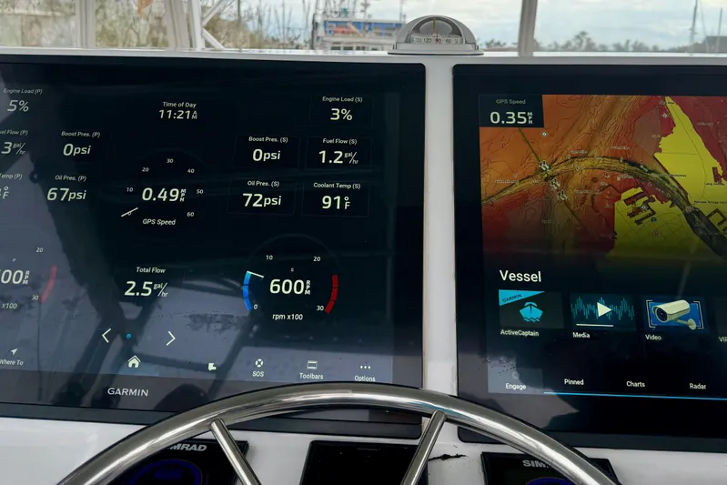 Pura Vida Yacht Photos Pics 1985 Bertram 54 Convertible dashboard with navigation and engine data displays.