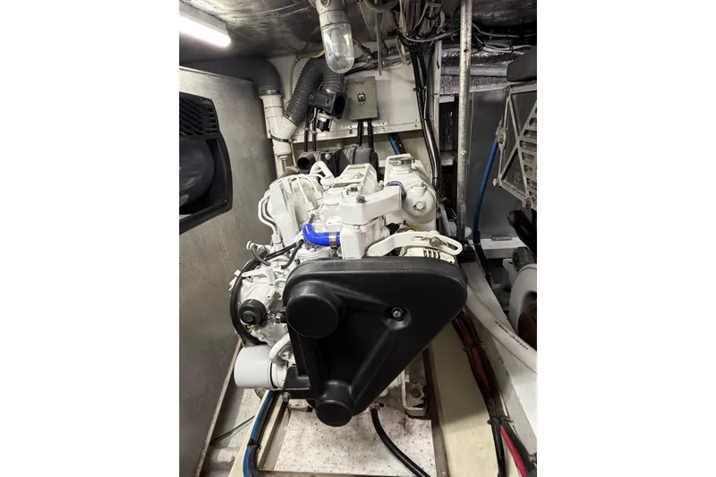 Pura Vida Yacht Photos Pics Engine room of a 1985 Bertram 54 Convertible yacht, showcasing mechanical components.