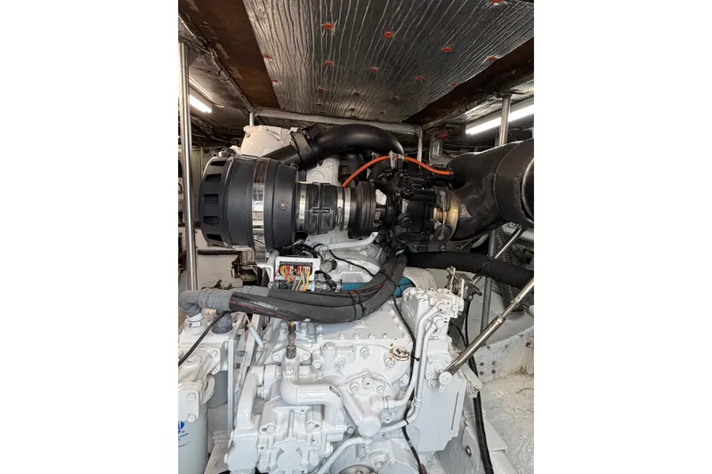 Pura Vida Yacht Photos Pics Engine room of a 1985 Bertram 54 Convertible yacht, showcasing detailed machinery.