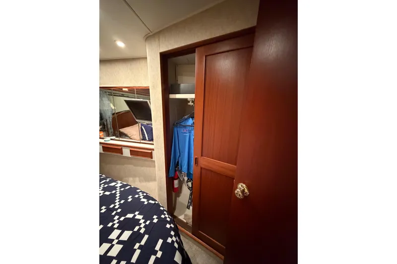 Pura Vida Yacht Photos Pics Interior of 1985 Bertram 54 Convertible yacht with wooden closet and bed.