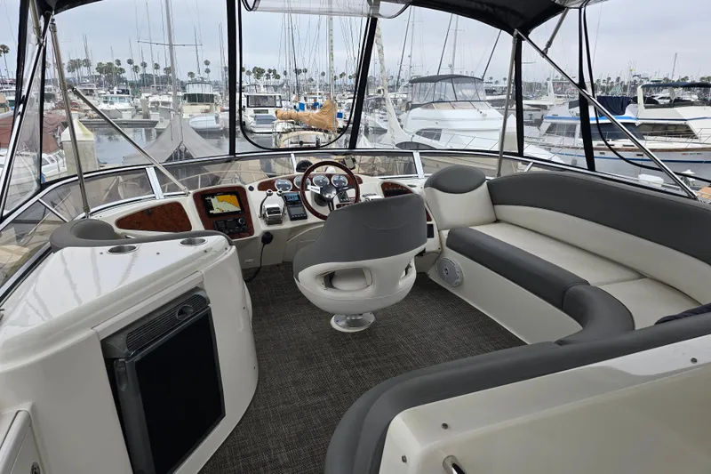 Embracing Life Yacht Photos Pics 2004 Meridian 459 Motoryacht helm with luxurious seating and marina view.
