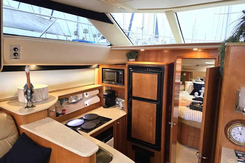 Embracing Life Yacht Photos Pics Luxurious interior of 2004 Meridian 459 Motoryacht with kitchen and cozy bedroom.