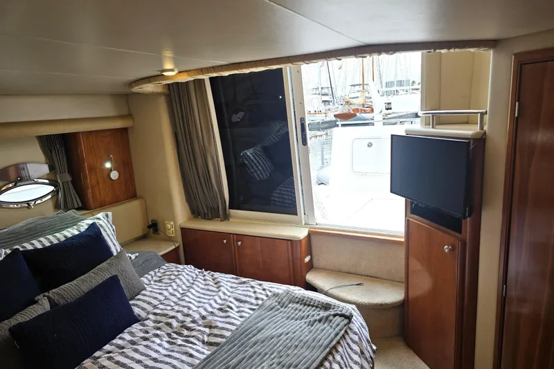 Embracing Life Yacht Photos Pics Luxurious 2004 Meridian 459 Motoryacht cabin with cozy bed and marina view.