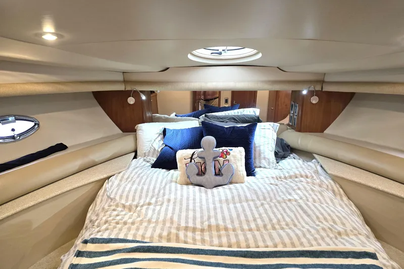 Embracing Life Yacht Photos Pics Cozy bedroom in 2004 Meridian 459 Motoryacht with nautical-themed decor.