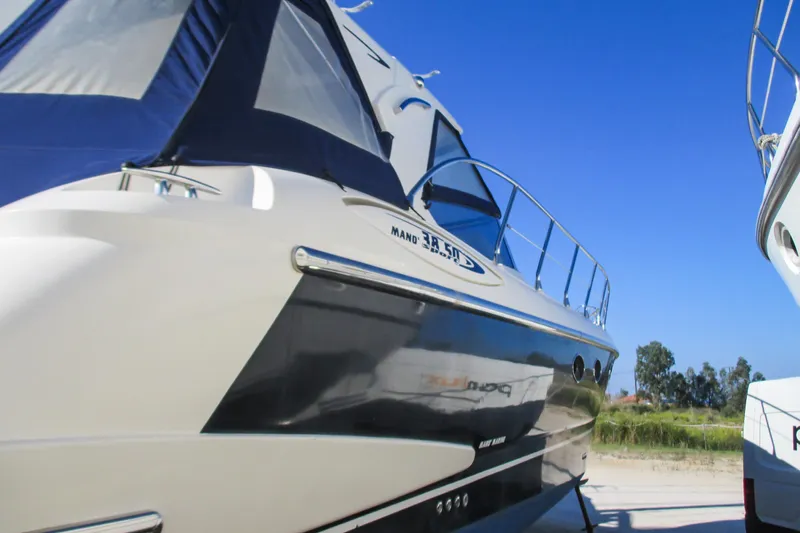 Manon Yacht Photos Pics 2008 Mano Marine 38.50 yacht with sleek design against clear blue sky.