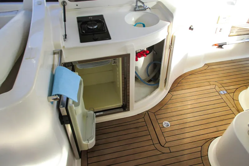 Manon Yacht Photos Pics Mano Marine 38.50 yacht kitchen area with sink, stove, and wooden flooring, 2008 model.