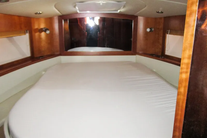 Manon Yacht Photos Pics Interior cabin of 2008 Mano Marine 38.50 yacht with wooden finish and bed.