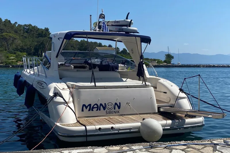 Manon Yacht Photos Pics 2008 Mano Marine 38.50 yacht docked by the water, featuring sleek design and spacious deck.