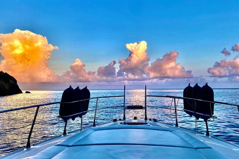 Manon Yacht Photos Pics Mano Marine 38.50 yacht at sea, vibrant sunset clouds, 2008 model.