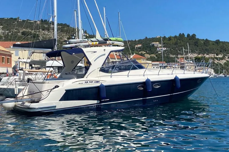 Manon Yacht Photos Pics 2008 Mano Marine 38.50 yacht docked in a scenic marina, surrounded by clear blue water.