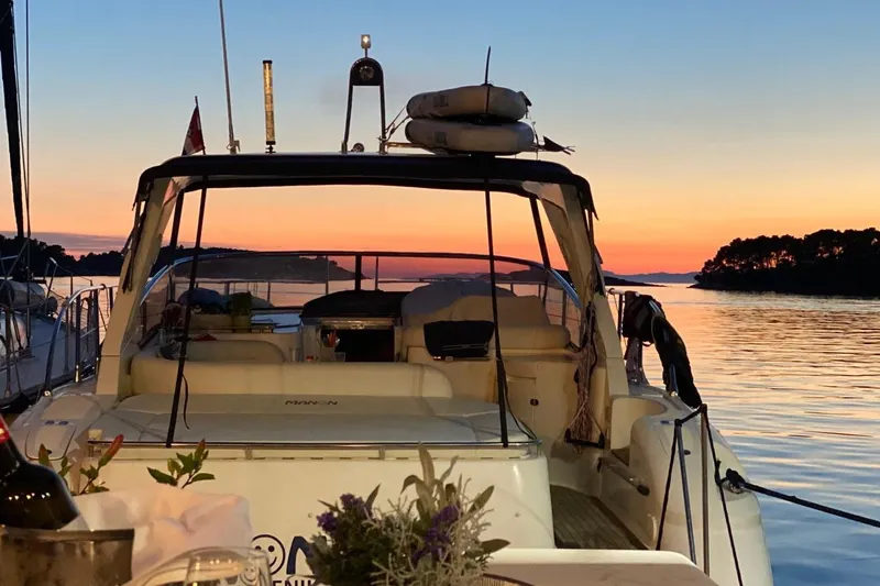 Manon Yacht Photos Pics 2008 Mano Marine 38.50 yacht at sunset, docked by calm waters.