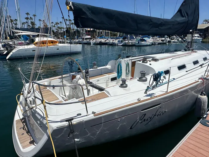 Pacifico Yacht Photos Pics Beneteau First 44.7 sailboat, 2005 model, docked in a marina with other boats.