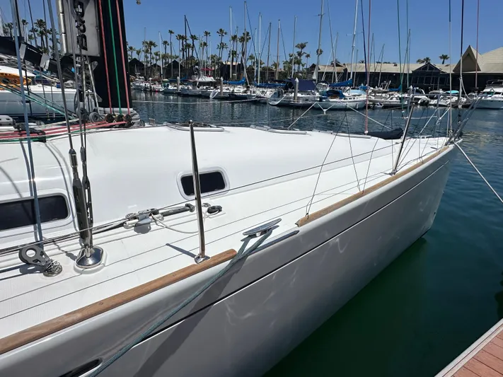 Pacifico Yacht Photos Pics 2005 Beneteau First 44.7 sailboat docked in a marina, surrounded by other boats.